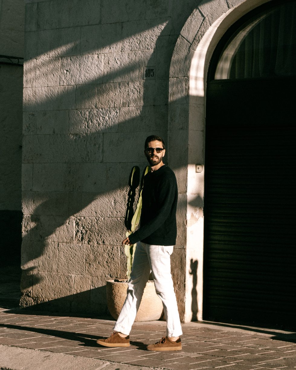 Jose in the late afternoon light outside an arched doorway